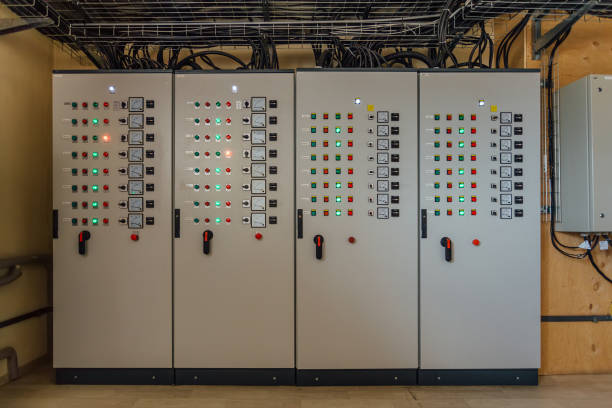 istock Electrical switchgear cabinets with control panels with indicator lights in factory 1168244466