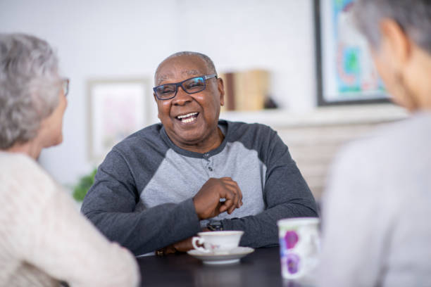 istock Senior man laughing with friends 1168246593