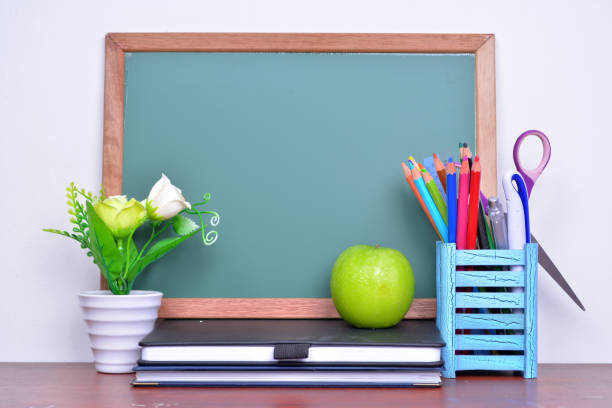 istock Back to School concept with apple on table in front of chalkboard 1168246644