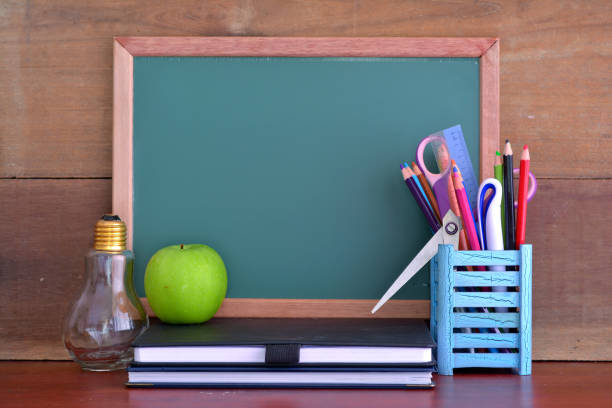 istock Back to School concept with apple on table in front of chalkboard 1168246749