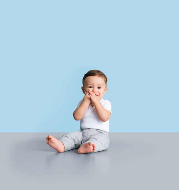 Infant putting his hand in his mouth
