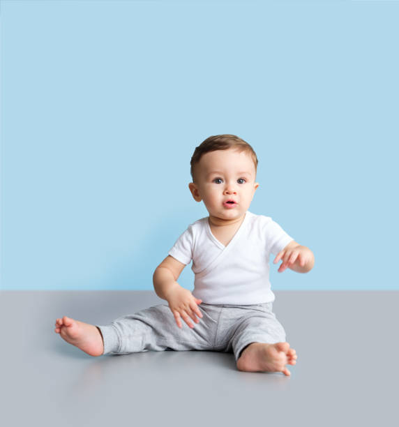istock Beautiful baby boy on a blue background 1168249871