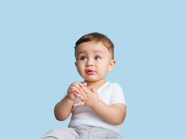 istock Baby boy playing with his fingers 1168249894
