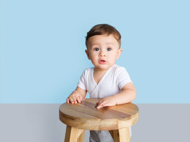 istock Toddler playing with a wooden stool 1168249898