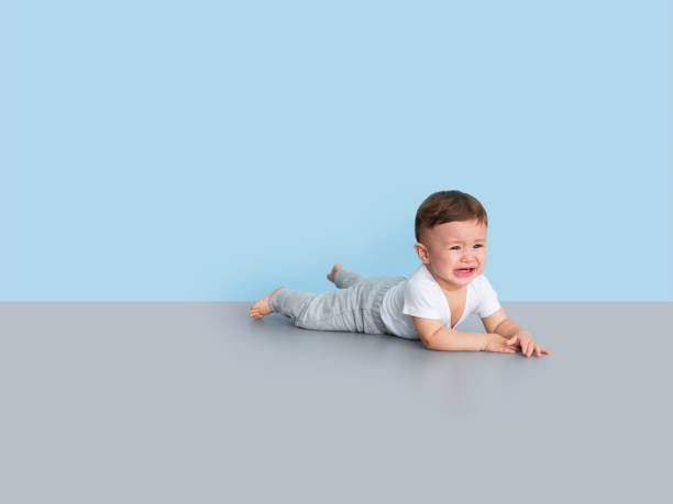 istock Toddler laying on the floor crying 1168249901