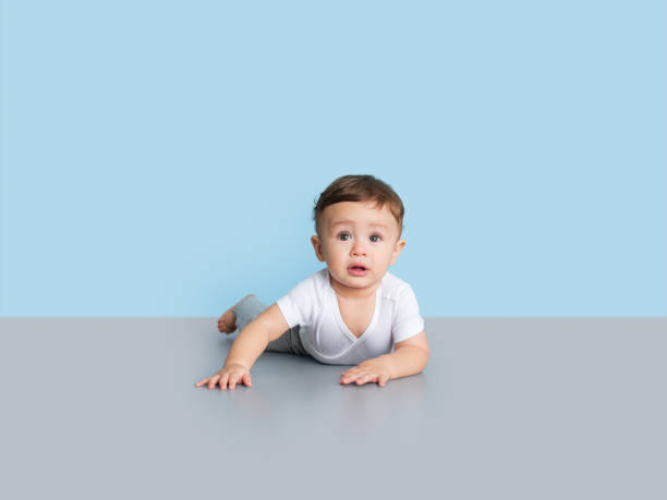 istock Serious baby boy looking away from the camera 1168249905