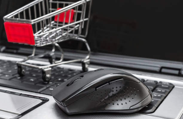 istock Computer mouse with shopping cart on laptop keyboard. Online shopping concept. 1168250124
