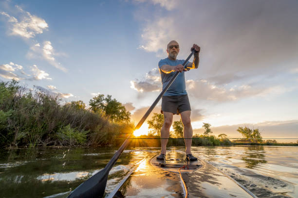 istock stand up paddling at sunset 1168251425