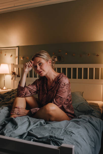 istock Real woman in pyjamas relaxing in bedroom 1168251621