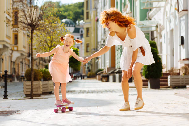 istock Happy pupil going skateboarding with her mom 1168252734