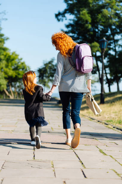 istock Cheerful red-haired female person looking at her kid 1168252891
