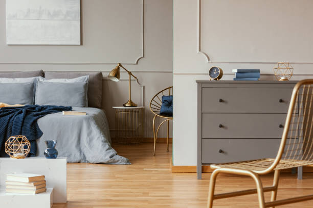 istock Elegant bedroom interior with king size bed, painting on the wall and grey commode 1168253265