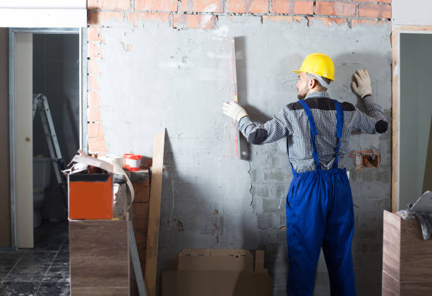 istock Worker is working with level near the wall at the object indoors. 1168254641