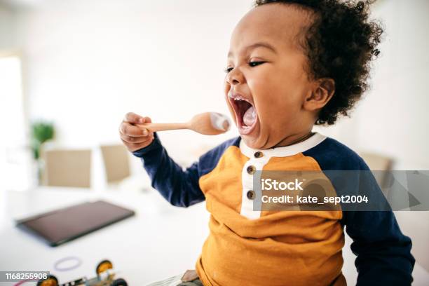 Toddler Eating Yogurt Stock Photo - Download Image Now - Eating, Baby - Human Age, Child