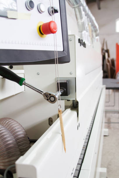 istock Side view on single sided automatic edge banders in a private furniture workshop, selective focus 1168256069
