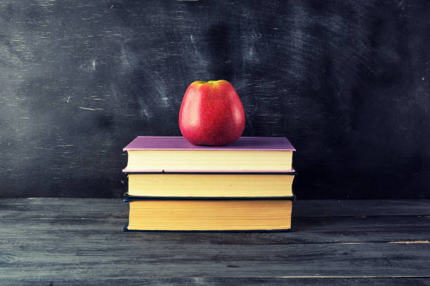 istock red ripe apple lies on a stack of books 1168257747