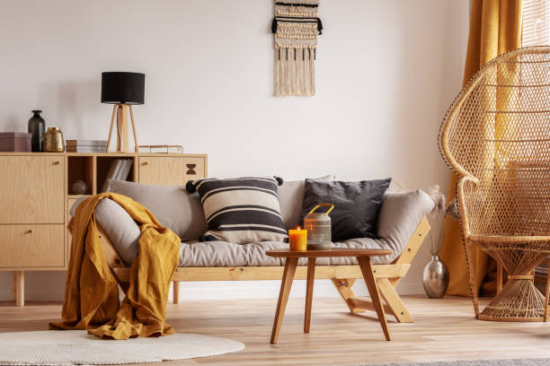 istock Stunning wicker peacock chair next to modern scandinavian settee with pillows 1168257964
