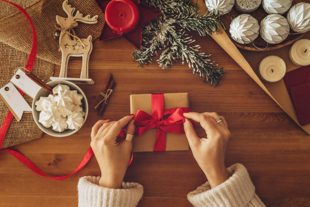 istock Woman wrapping Christmas gifts 1168259558