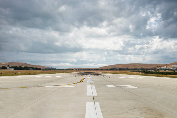 istock Runway at the airport in a cloudy day. 1168259788