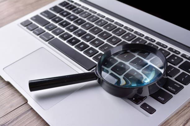 istock Laptop computer with magnifying glass, concept of search 1168261120