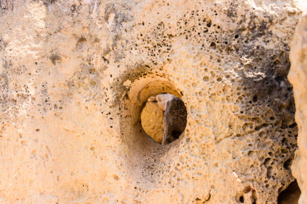 Round hole through one of the stones at the ancient megalithic temple of Gigantija, Xaghra, Gozo, Malta.  It is believed these holes are for poles to lock doors shut.