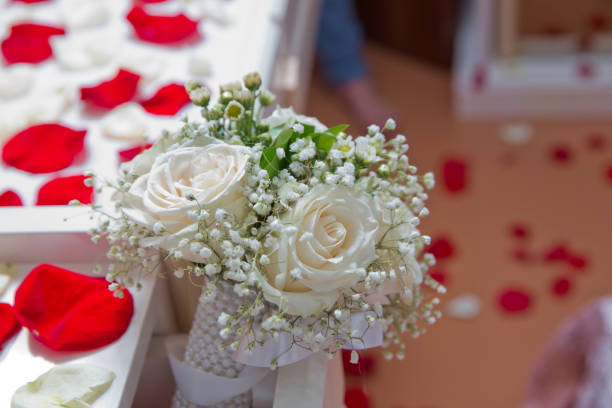 White flower bouquet for the wedding. Red petals . bedom mirror