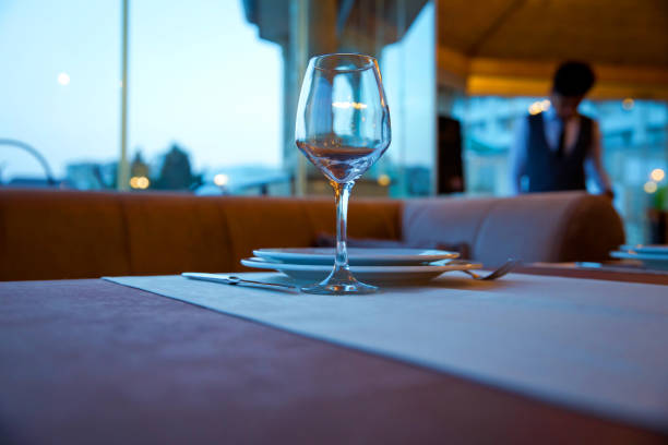 istock Selective focus. Empty glasses set in restaurant . Closeup image of empty glass ar blurred restaurant background. Close up picture of empty glasses in restaurant. 1168269805