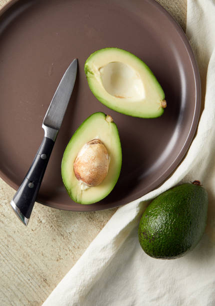 istock Overhead view of sliced avocado in plate