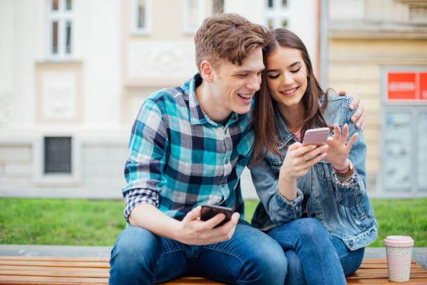 istock Young happy couple using their smartphones 1168278091