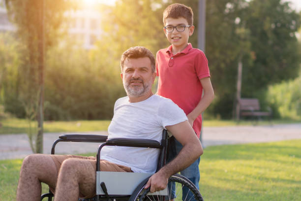 istock Young boy with disabled father in park 1168278293