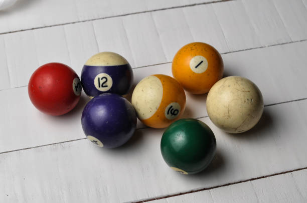 istock Old billiard balls on white wooden table background 1168279177