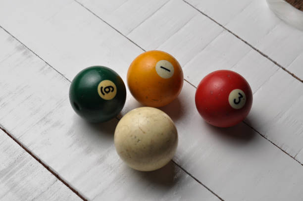 istock Old billiard balls on white wooden table background 1168279179