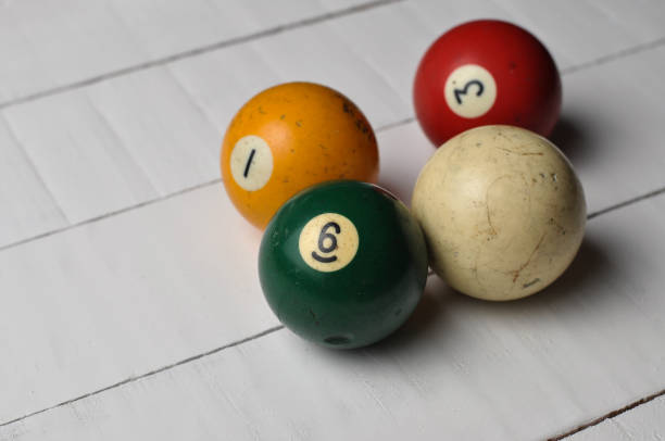 istock Old billiard balls on white wooden table background 1168279181