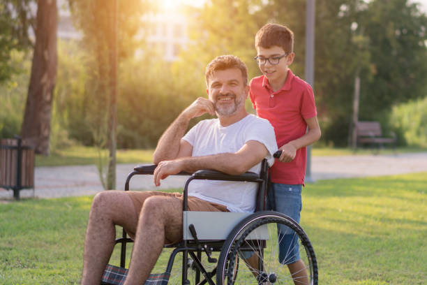 istock Happy boy with disabled father in park 1168279513