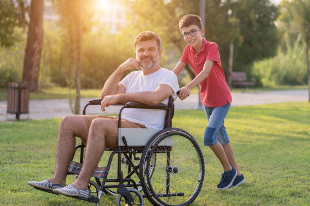 istock Happy boy with disabled father in park 1168280045