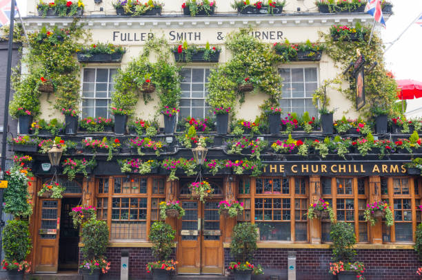 The Churchill Arms, the London's most famous pub London, England - 12 June 2019: The Churchill Arms, the London's most famous pub. Scenic victorian pub in Notting Hill, Kensington. The London's most colourful pub. winston churchill prime minister stock pictures, royalty-free photos & images