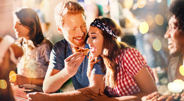 After party food time. Young couple eating pizza after party. food festival stock pictures, royalty-free photos & images