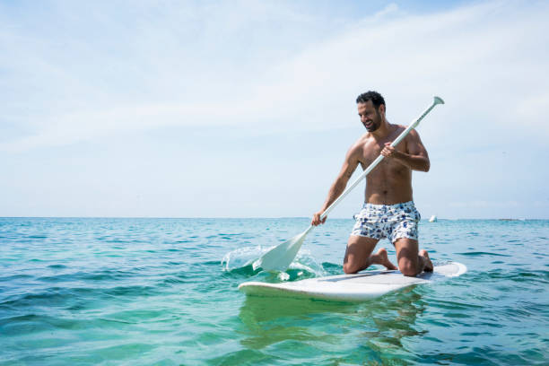 istock Man performing stand up paddle in ocean 1168282771