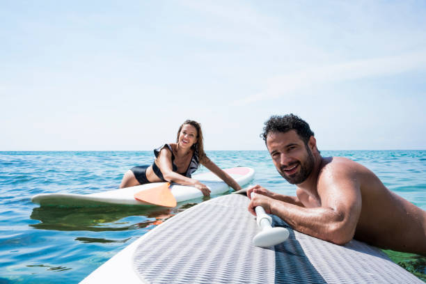 istock Couple in love performing stand up paddle in ocean 1168282818