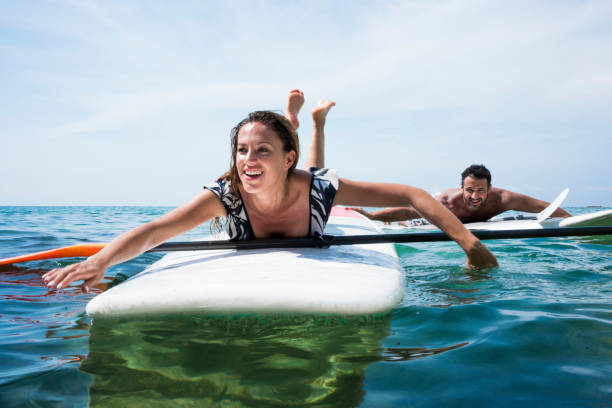 istock Couple in love performing stand up paddle in ocean 1168282842