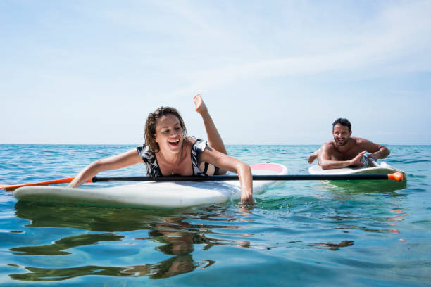 istock Couple in love performing stand up paddle in ocean 1168282927