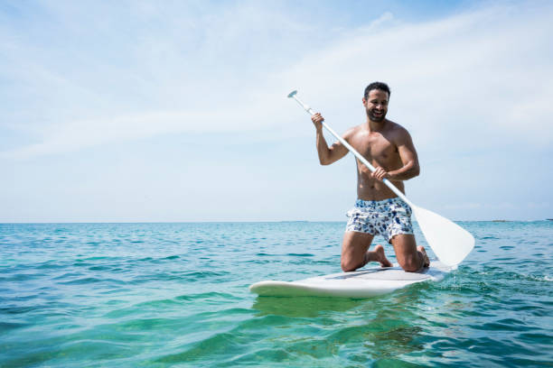 istock Man performing stand up paddle in ocean 1168283035