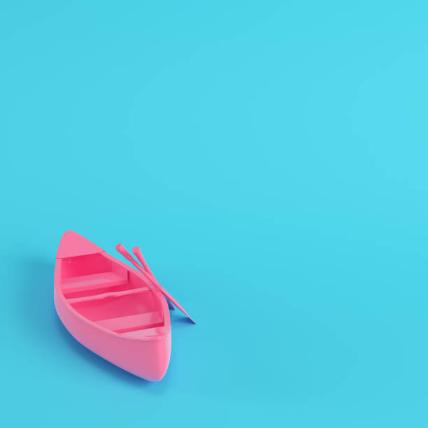 istock Pink canoe with paddles on bright blue background in pastel colors 1168286487