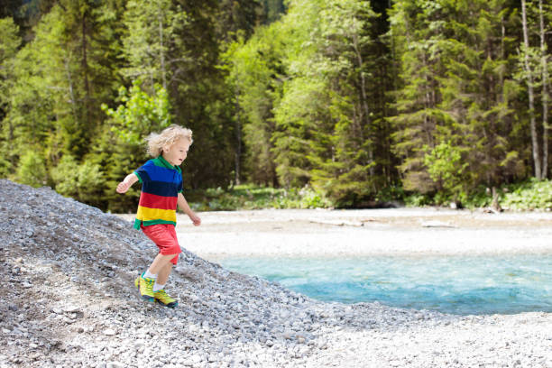 istock Child hiking in mountains. Kids at river shore. 1168287063