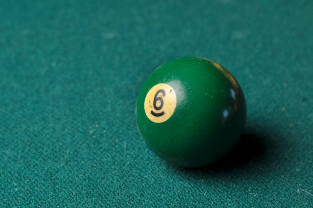 istock Old billiard ball number 6 green color on green billiard table, copy space 1168287119