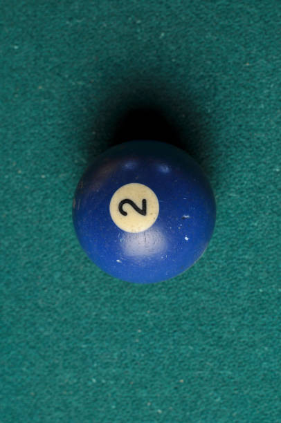 istock Old billiard ball number 2 blue color on green billiard table, copy space 1168287156