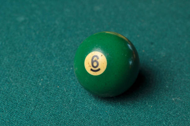 istock Old billiard ball number 6 green color on green billiard table, copy space 1168287157