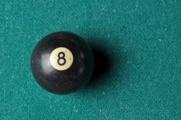 istock Old billiard ball number 8 black color on green billiard table, copy space 1168287216