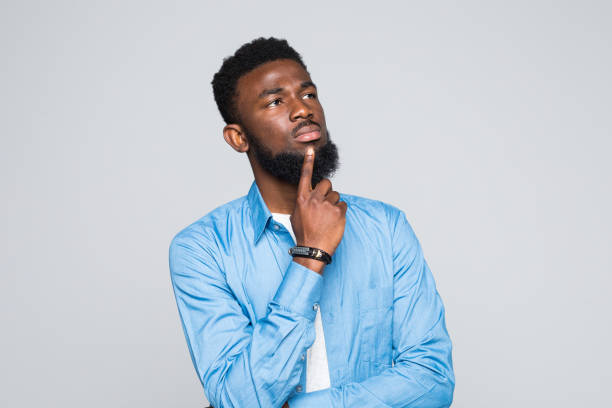istock Young handsome African man thinking isolated against white background 1168287233