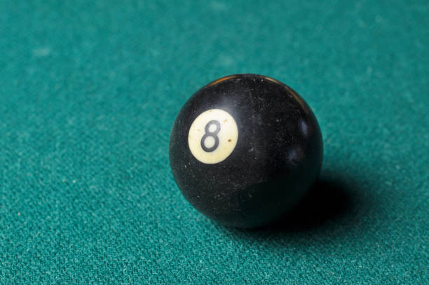 istock Old billiard ball number 8 black color on green billiard table, copy space 1168287270